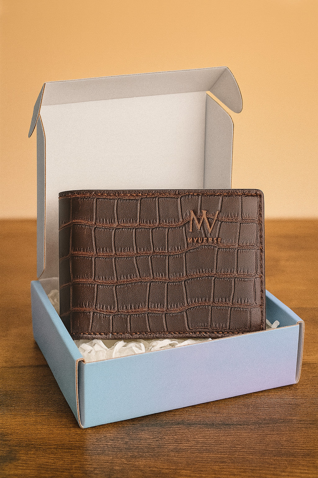 Brown leather wallet with gold logo in gift box