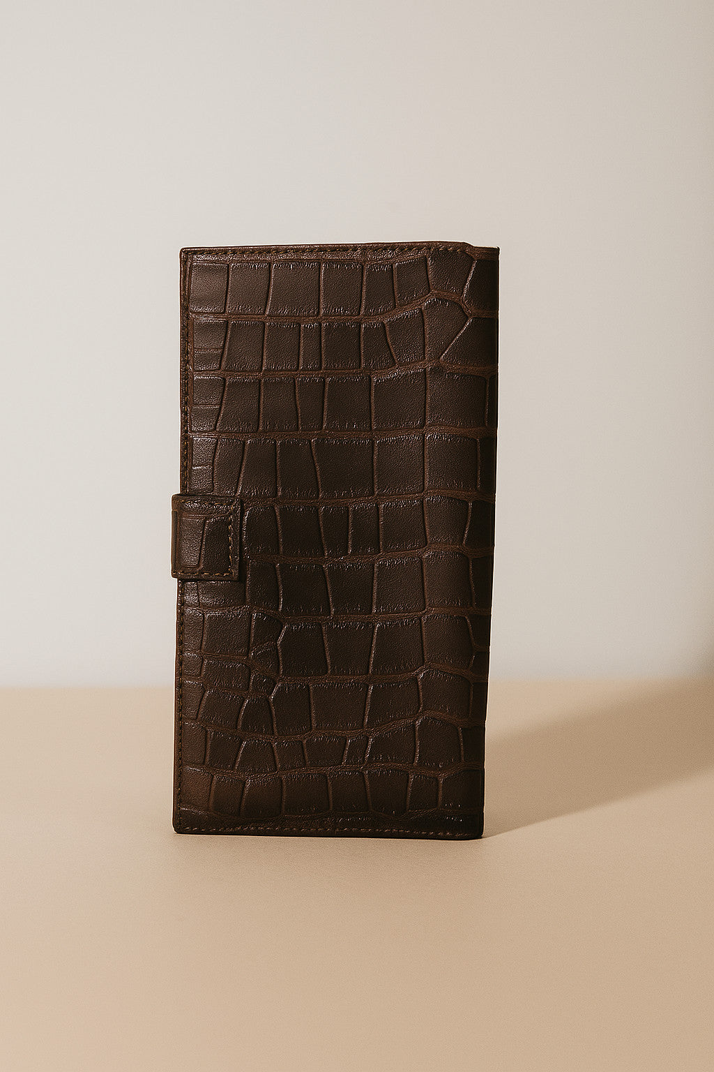 Croc-embossed leather travel clutch detail