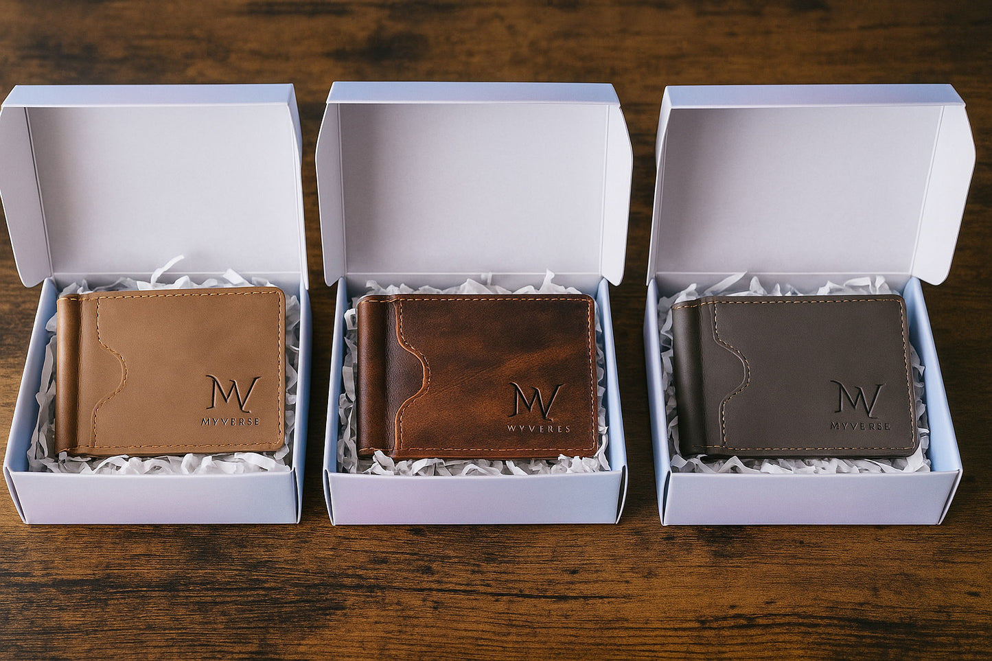 Three MVVERSE wallets in brown, tan, and black gift boxes